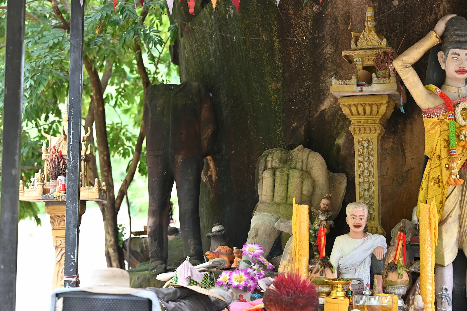 Concrete statues of Khmer Rouge soldiers with missing heads at a historical memorial in Cambodia.