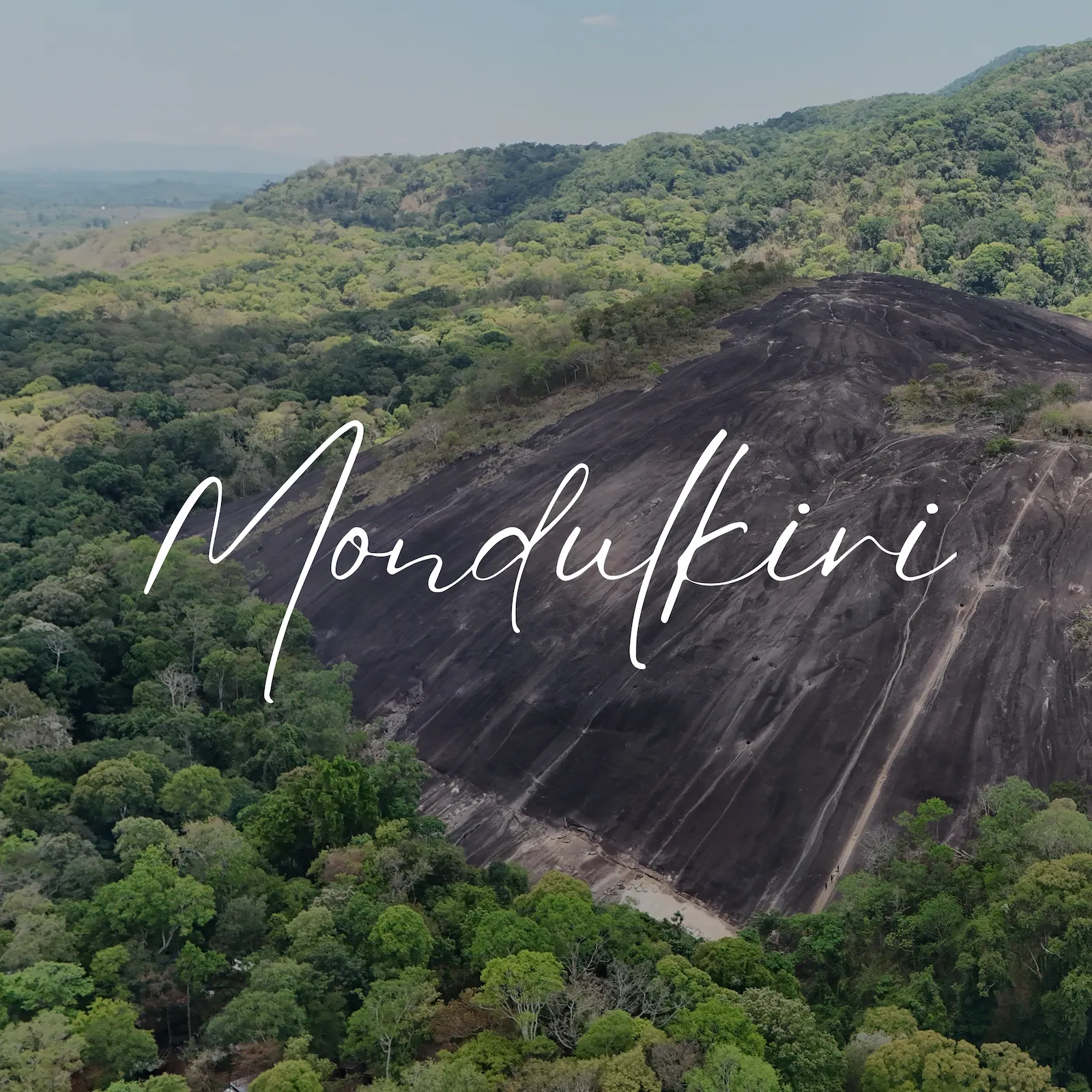 Aerial photograph showing dense forest and a large basalt hill at Nam Lear in Mondulkiri.