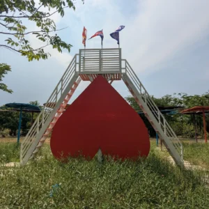 An upside down love heart with stairs to its point and flags on top.