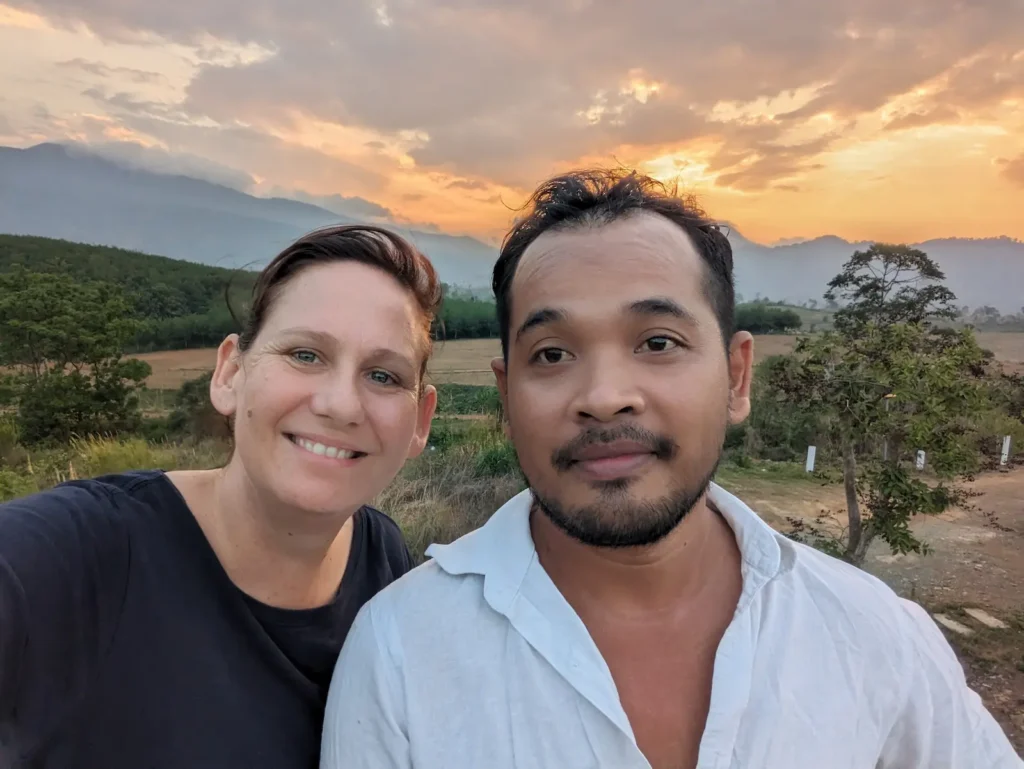 Mel and Nehru with hills and the sun setting behind them.