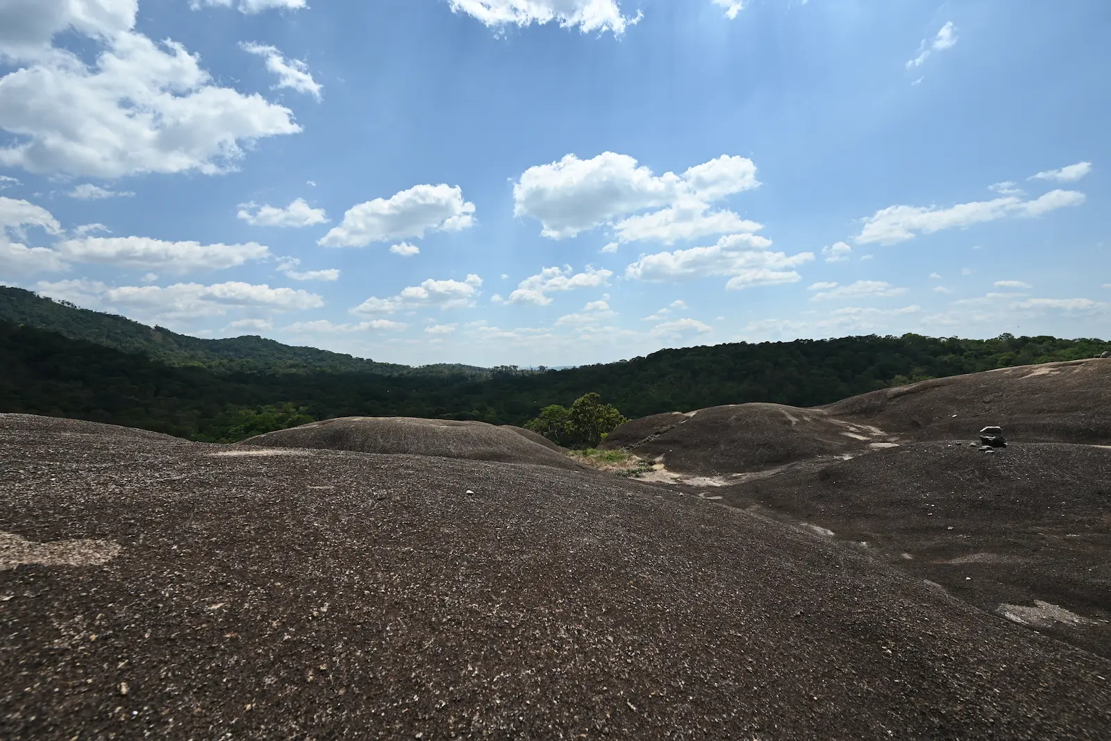 Nam Lear Rock with green forest in the background.