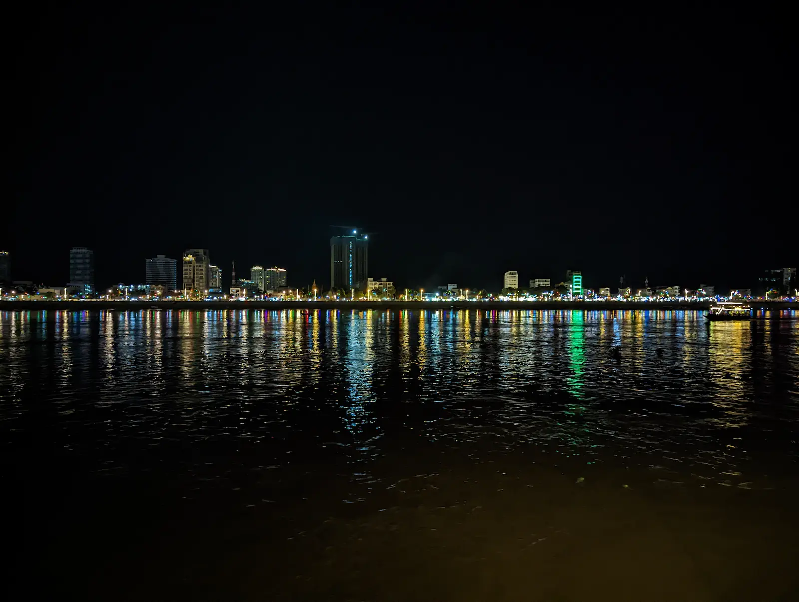 City lights of Phnom Penh reflecting in the water at night.