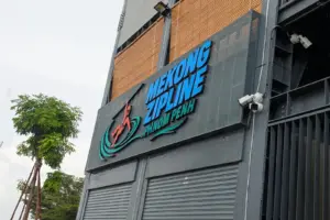 Front sign of the Mekong Zipline on a building.