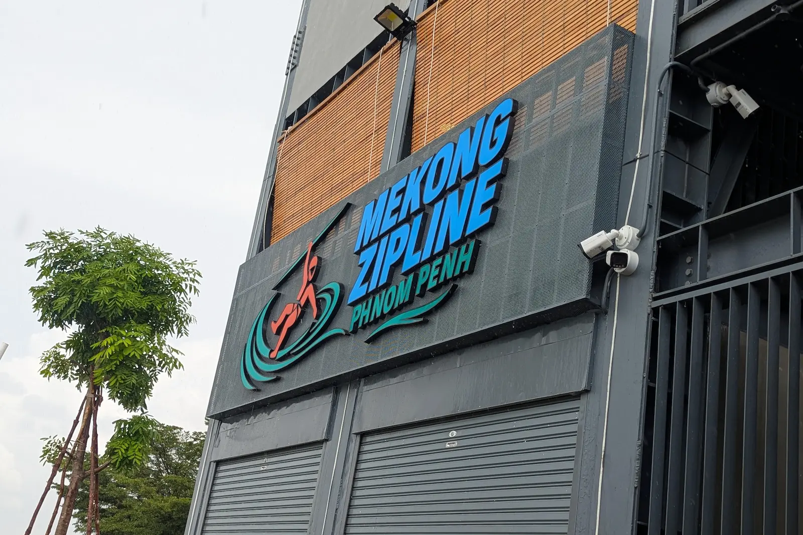 Front sign of the Mekong Zipline on a building.
