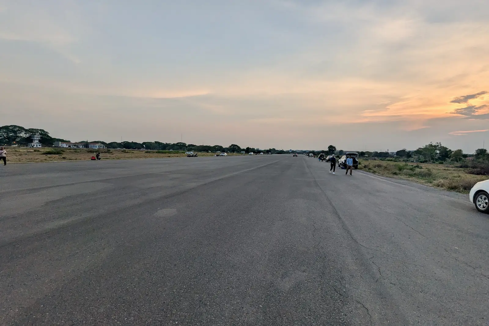 Along the Battambang airport runway, people have picnics.