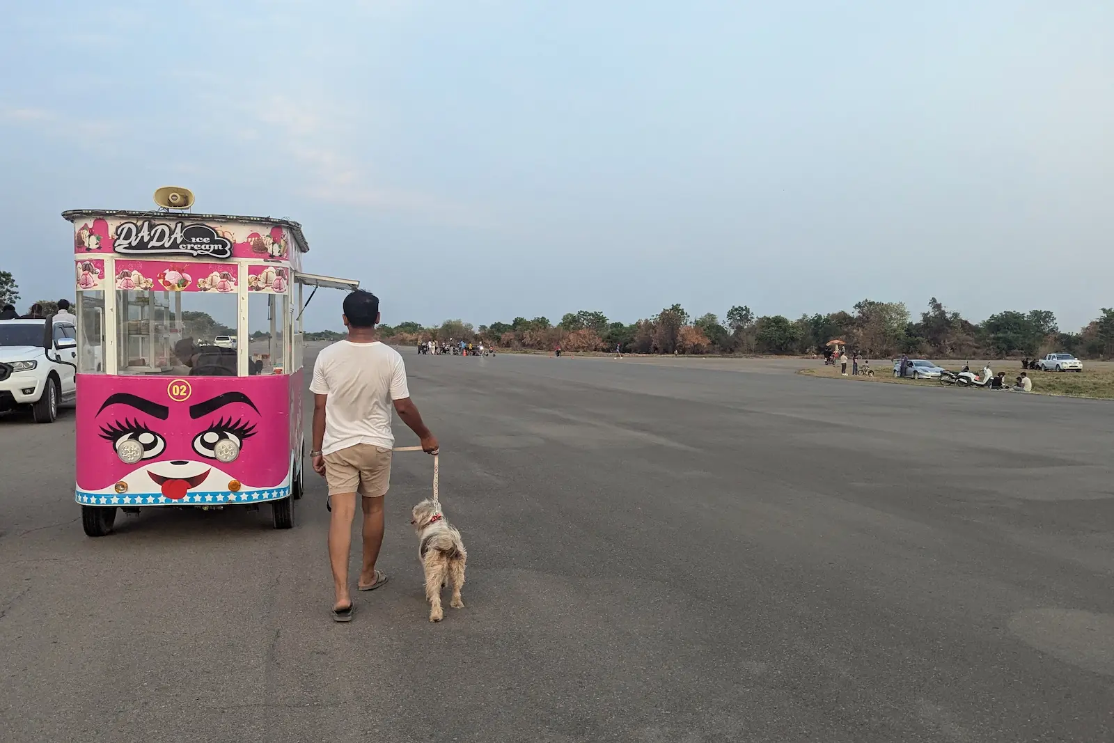 Nehru walks the dog next to an ice cream van at Battambang Airport