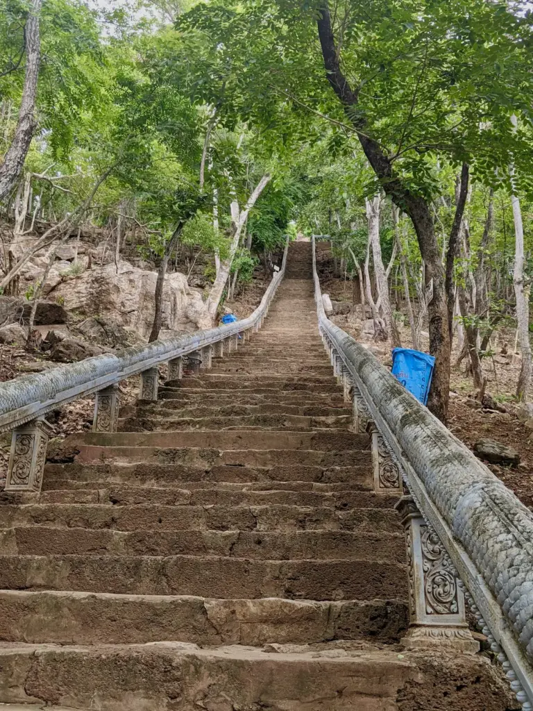Hundreds of stairs lead up a hill with a naga balustrade.